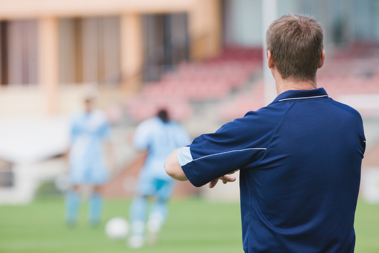 coach watching his team play