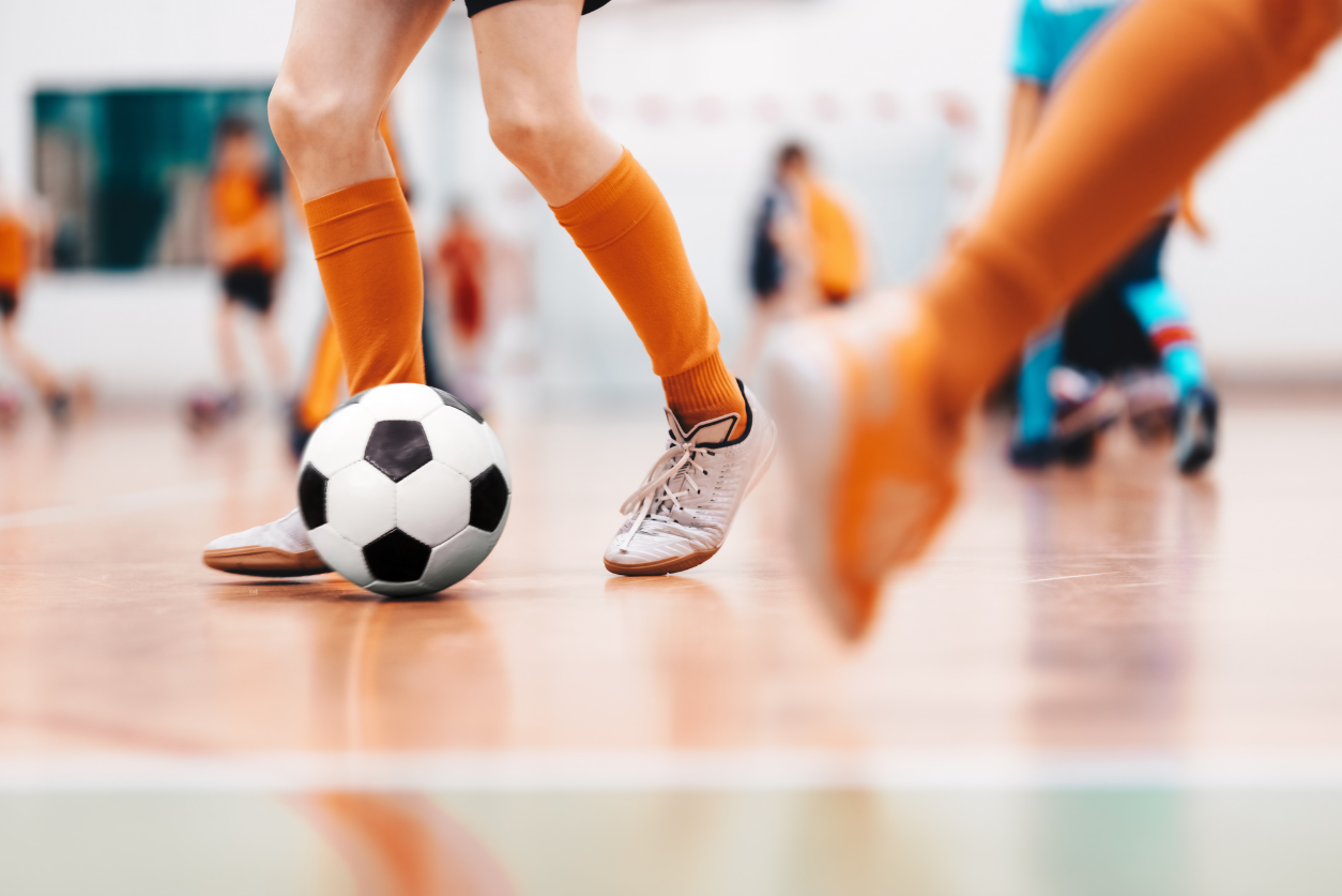 Close up of someone kicking a soccer ball